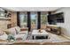 Bright living room with brick accent wall, large windows, and a comfortable sectional sofa at 5300 Tabor St, Arvada, CO 80002
