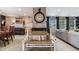 Inviting living room features a decorative brick wall with oversized clock and cozy seating at 5300 Tabor St, Arvada, CO 80002