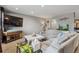 Inviting living room with neutral tones, large sectional, and modern entertainment center at 5300 Tabor St, Arvada, CO 80002
