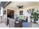 Covered porch with comfortable seating, ceiling fan, and access to dining room with a view at 5300 Tabor St, Arvada, CO 80002