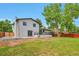 Spacious backyard features a lush lawn, mature trees, and patio space for outdoor entertaining and relaxation at 7684 S Ingalls St, Littleton, CO 80128