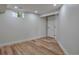 Basement bedroom with hardwood floors, recessed lighting, and a neutral color palette offers a flexible living space at 7684 S Ingalls St, Littleton, CO 80128