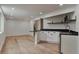 Basement bar area features a black countertop with wood accents, bright recessed lighting, and sleek cabinetry at 7684 S Ingalls St, Littleton, CO 80128