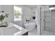 Modern bathroom featuring a freestanding tub, sleek fixtures, and a spacious vanity area at 7684 S Ingalls St, Littleton, CO 80128