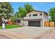 A charming two-story home with a well-manicured lawn, modern architectural details and a long driveway at 7684 S Ingalls St, Littleton, CO 80128