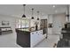 Spacious open-concept kitchen featuring a large island, stainless steel appliances, and a bright, airy atmosphere at 7684 S Ingalls St, Littleton, CO 80128