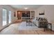 Stylish living room with a modern entertainment center, fireplace, hardwood floors, and comfortable seating at 7684 S Ingalls St, Littleton, CO 80128