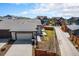 Aerial view of the home and neighborhood, showcasing the spacious driveway, back yard, and curb appeal at 9051 E 61St Ave, Denver, CO 80238