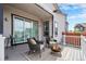 Relaxing covered back deck with fire pit, comfy furniture, and serene outdoor space at 9051 E 61St Ave, Denver, CO 80238