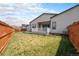 Large backyard with a manicured lawn, patio, privacy fence, and comfortable outdoor living at 9051 E 61St Ave, Denver, CO 80238