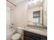 Bright bathroom features a modern vanity, shower, tub, and neutral color palette at 9051 E 61St Ave, Denver, CO 80238