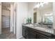 Bathroom with gray countertops, dark wood cabinets, and decorative plants for a spa-like experience at 9051 E 61St Ave, Denver, CO 80238