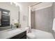 Stylish bathroom with herringbone tile, modern fixtures, and a combination shower and tub at 9051 E 61St Ave, Denver, CO 80238