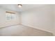 Simple, light-filled bedroom with neutral carpet and a window with bamboo shade at 9051 E 61St Ave, Denver, CO 80238