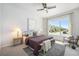 Bright and airy bedroom with a large window and ceiling fan at 9051 E 61St Ave, Denver, CO 80238