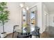 Modern dining room with a glass table, black chairs, unique lighting, and stylish decor at 9051 E 61St Ave, Denver, CO 80238