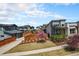 Charming home with a well-manicured lawn, blooming tree, and gray exterior at 9051 E 61St Ave, Denver, CO 80238