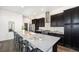 Modern kitchen with a large center island, stainless steel appliances, and ample cabinet space at 9051 E 61St Ave, Denver, CO 80238