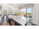 Bright open kitchen with an island and access to a patio at 9051 E 61St Ave, Denver, CO 80238