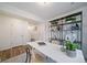 Stylish office showcases a bright white desk, decorative shelving, and sleek hardwood floors at 46559 Avery Ln, Bennett, CO 80102