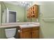 Clean bathroom with wood vanity and a large mirror at 14442 E 102Nd Pl, Commerce City, CO 80022
