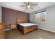 Primary bedroom with ceiling fan and ensuite bathroom access at 14442 E 102Nd Pl, Commerce City, CO 80022