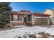 Gray house with red accents and a two-car garage at 14442 E 102Nd Pl, Commerce City, CO 80022