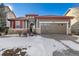 Gray house with red accents and a two-car garage at 14442 E 102Nd Pl, Commerce City, CO 80022