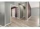 Bright hallway with wood-look floors and built-in shelves at 14442 E 102Nd Pl, Commerce City, CO 80022