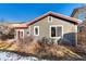 Gray house exterior with red trim, deck, and landscaping at 14442 E 102Nd Pl, Commerce City, CO 80022