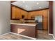 Kitchen with wood cabinets and stainless steel appliances at 14442 E 102Nd Pl, Commerce City, CO 80022