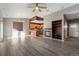 Living room with hardwood floors, fireplace, and kitchen view at 14442 E 102Nd Pl, Commerce City, CO 80022