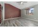 Living room with hardwood floors and a large window at 14442 E 102Nd Pl, Commerce City, CO 80022