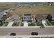 Aerial view of home with fenced backyard in a neighborhood, near a large open green space at 7414 Blue River Ave, Frederick, CO 80530