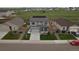 Aerial view of the home featuring a well-manicured lawn, solar panels, and a two-car garage at 7414 Blue River Ave, Frederick, CO 80530