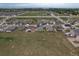 High aerial view capturing the home's setting in a residential area with nearby green spaces at 7414 Blue River Ave, Frederick, CO 80530