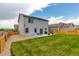 A fully fenced backyard, complete with a patio area perfect for outdoor dining and entertaining at 7414 Blue River Ave, Frederick, CO 80530