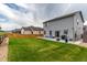 Spacious backyard featuring a well-maintained lawn, patio seating, and privacy fence at 7414 Blue River Ave, Frederick, CO 80530