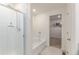 Bright bathroom features a glass enclosed shower, soaking tub, and walk-in closet at 7414 Blue River Ave, Frederick, CO 80530