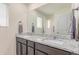Elegant bathroom features a double sink vanity with granite countertops and stylish fixtures at 7414 Blue River Ave, Frederick, CO 80530