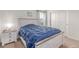 Charming bedroom with a plush bed, side table, and window for natural light at 7414 Blue River Ave, Frederick, CO 80530