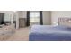 Bedroom with plush carpeting, large window, and a dresser on the left at 7414 Blue River Ave, Frederick, CO 80530