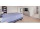 Bedroom with plush carpeting, large window, dresser, and TV at 7414 Blue River Ave, Frederick, CO 80530