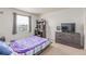 Cozy bedroom with a large window, desk, dresser, and comfortable bed at 7414 Blue River Ave, Frederick, CO 80530