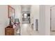 Inviting entryway featuring stylish flooring, a console table, and a staircase leading to the upper level at 7414 Blue River Ave, Frederick, CO 80530