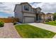 Charming two-story home boasting a well-maintained lawn, lush landscaping, and attached two car garage at 7414 Blue River Ave, Frederick, CO 80530