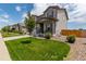 Beautiful two-story home boasting a well-maintained lawn, covered porch, and lush landscaping at 7414 Blue River Ave, Frederick, CO 80530