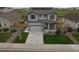 Beautiful two-story home featuring solar panels, a well-manicured lawn, and an attached two car garage at 7414 Blue River Ave, Frederick, CO 80530