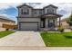 Charming two-story home with a well-maintained lawn, covered porch and attached two car garage at 7414 Blue River Ave, Frederick, CO 80530