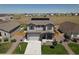 Attractive two-story house with a spacious front yard, two-car garage, and solar panels on the roof at 7414 Blue River Ave, Frederick, CO 80530